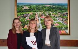 osoby stojące z dyplomami