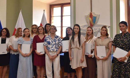burmistrz oraz nauczycieli pozują do wspólnego zdjęcia